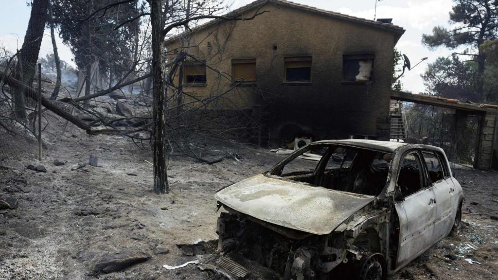 Coche y casa calcinadas por el incendio de Burgohondo que afecta a 19 pueblos en despoblación en España.