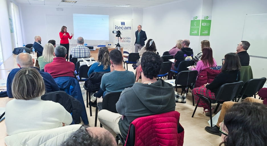 Ponentes de ITECAM impartiendo una jornada formativa ante un grupo numeroso de asistentes sentados.